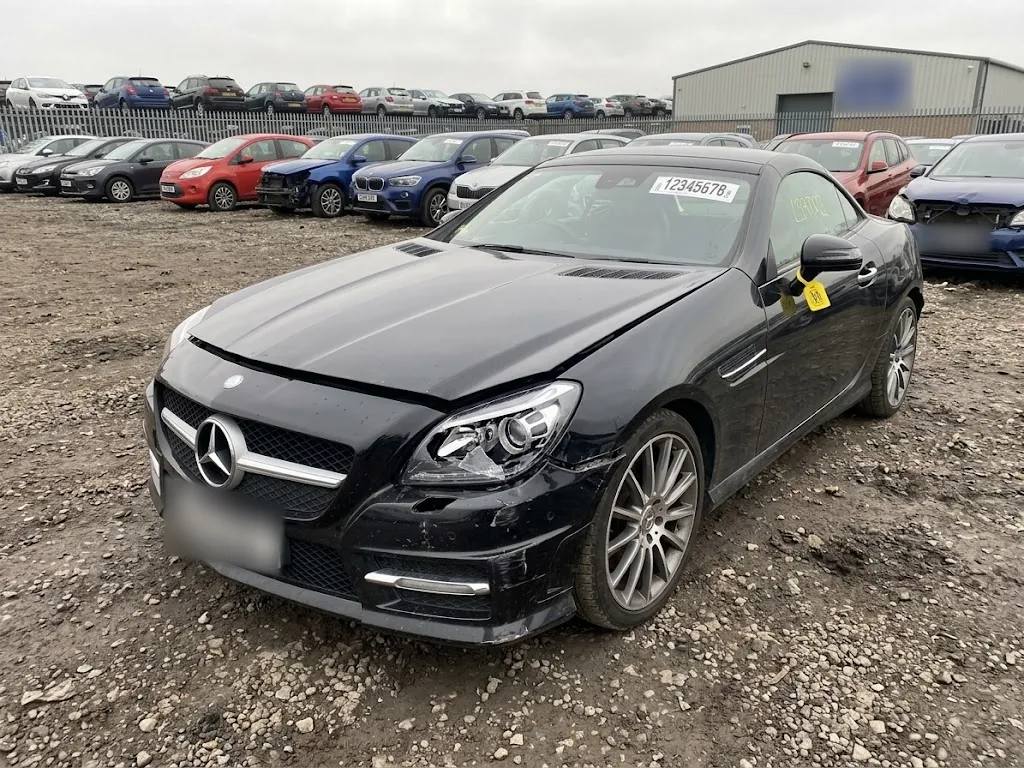 Black Mercedes-Benz SLK with front-end damage in a Copart UK yard