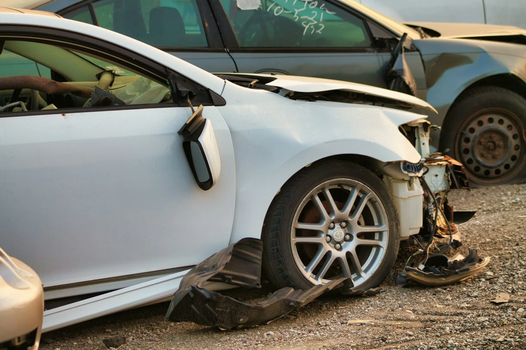 Lot photo 10: white car with front-end damage